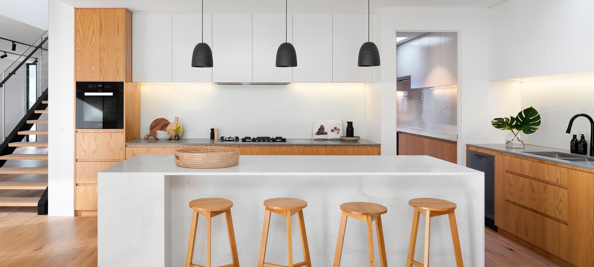 Bright white kitchen with island and warm wood floors